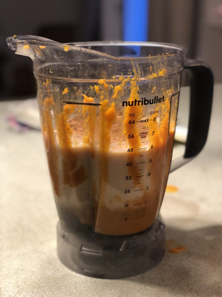 Blender with unblended raw milk pumpkin smoothie