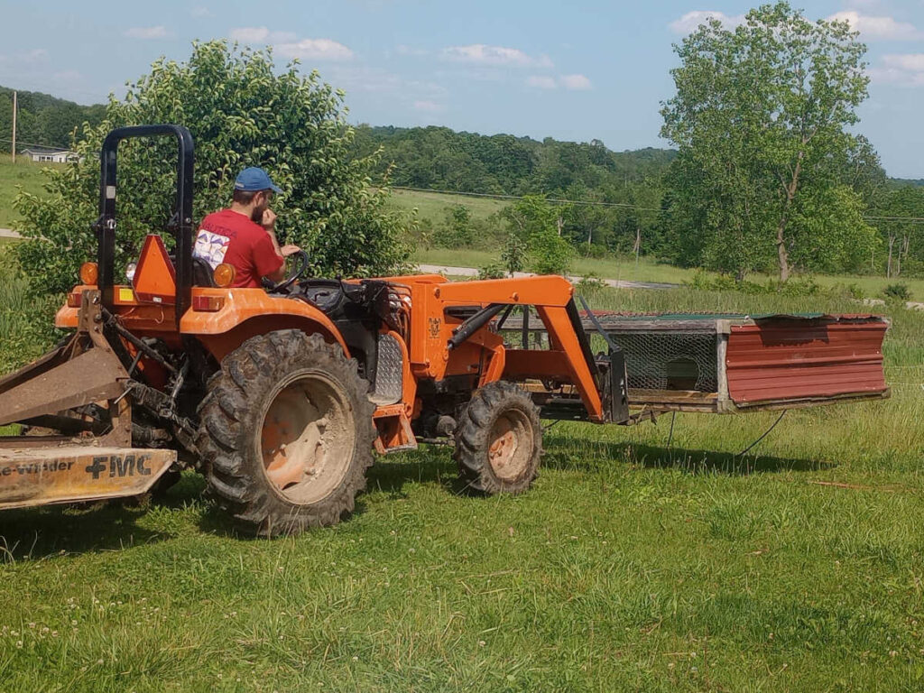 Tractor carrying meat chicken tractor