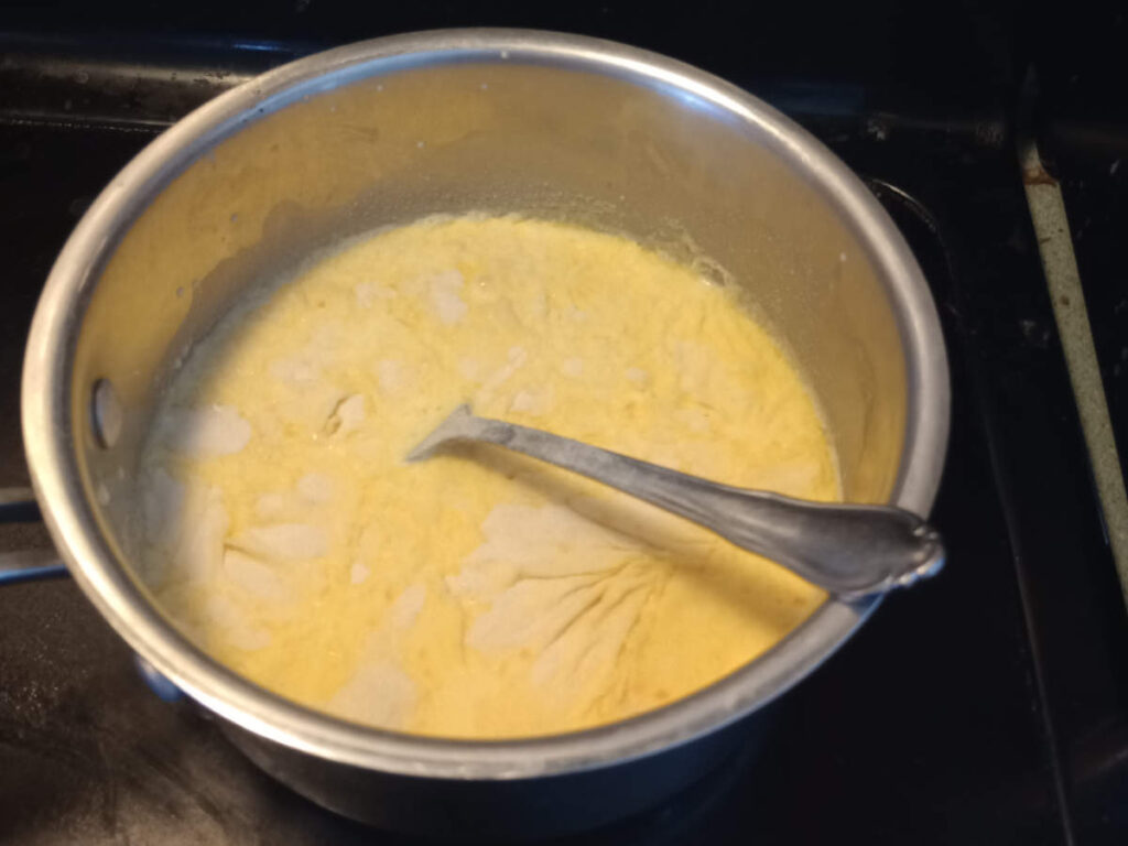 Cream in saucepan with gelatin sprinkled over the top