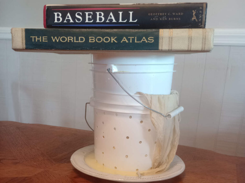 Cheese press made from plastic buckets.